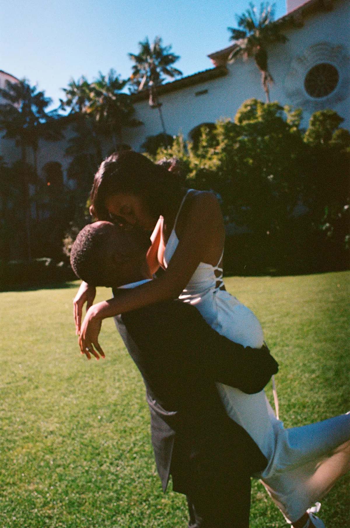A groom carrying his bride — a frame that feels like motion
