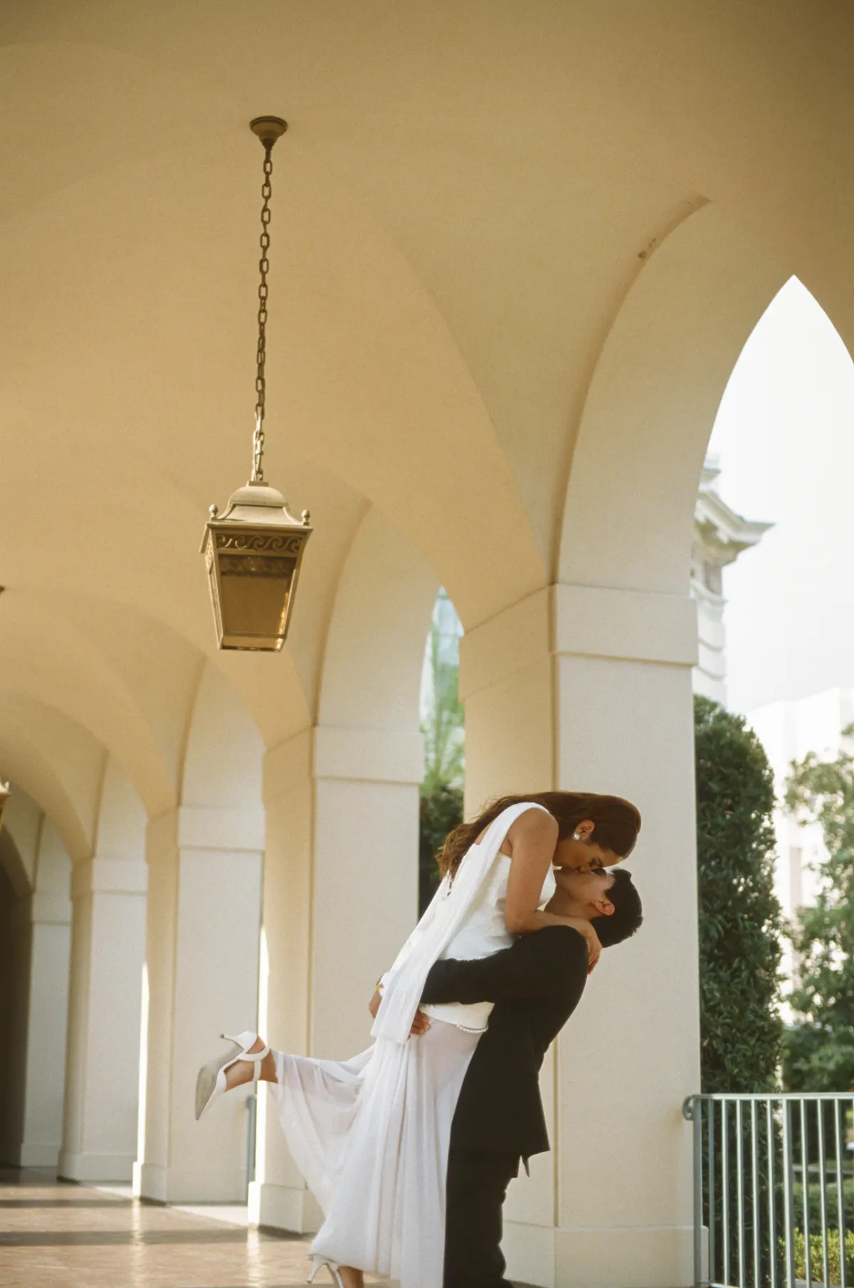 Groom lifting bride — full-day Super 8 cinematic moment