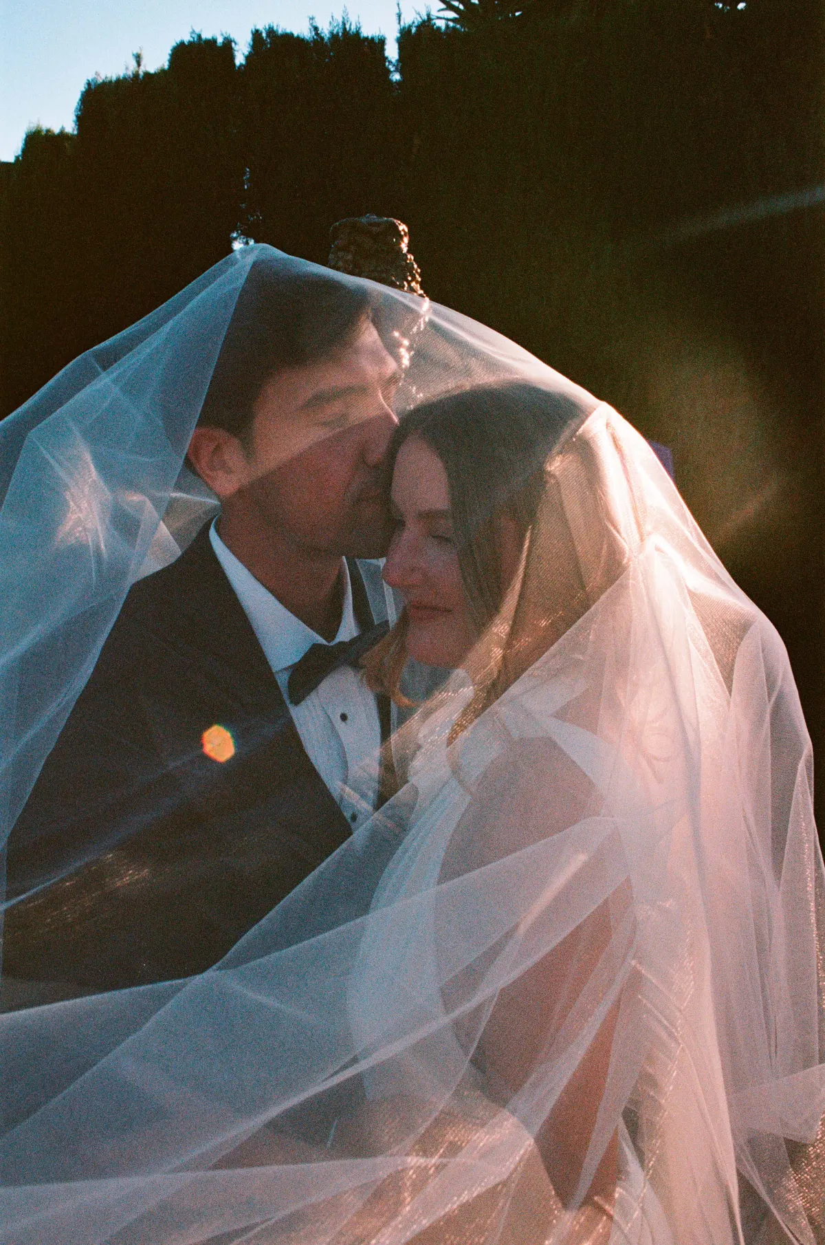 Bride and groom under a sunlit veil — a Super 8 still