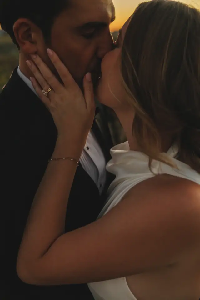 Close-up of the newlyweds kissing during their Villa de Amore wedding